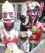 An artist gives finishing touches to the effigies of Ravan and Meghnath