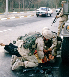 US Army troops attend to a wounded man