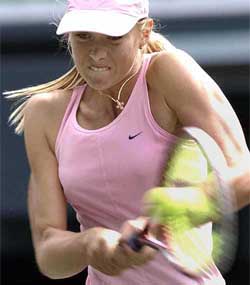 Maria Sharapova of Russia returns a ball against Zheng Jie