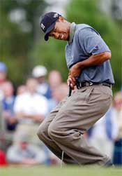 Tiger Woods reacts during his put on the ninth green
