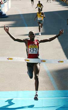 Kenyan runner Martin Lel crosses the finish line