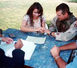 Pensacola Florida National Guard Sgt. Sean Blackwell of Pace, Fla., exchanges wedding bands