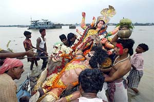 Devotees immerse an idol of Goddess Durga