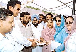 Ms Preneet Kaur, MP, gives a cheque for Rs 35 lakh to Mr Chand Rana, Sarpanch of Mubarikpur village, during a function at the village, near Dera Bassi, on Monday.