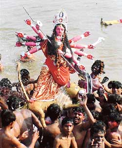 Devotees carry an idol of Goddess Durga for immersion into the Sutlej near Phillaur