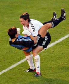 Germany's Birgit Prinz and goalie Silke Rottenberg celebrate after beating the United States