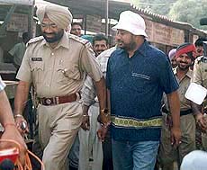 Shamsher Mehndi being brought out of the Patiala district court complex after his police remand was extended on Tuesday.