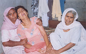 Ravi�s sister cries inconsolably after the news of his murder reached Dhamot village