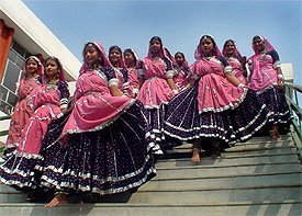 A team of folk dancers stepping down the hall of Kundan Vidya Mandir after taking part in inter-school Sahodaya competition