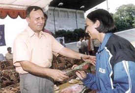 Sports Authority of India director-general Shekhar Dutt being welcomed