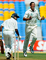 New Zealand's Daryl Tuffy grimaces in disappointment as India's Akash Chopra