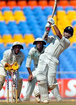 India's captain Saurav Ganguly hits a shot as New Zealand's wicketkeeper Robbie Hart