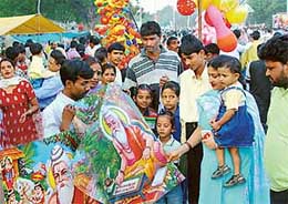 Residents gather round the portrait of Maharishi Valmiki on the occasion of Maharishi Valmiki Jayanti in Chandigarh on Friday. 