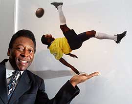 Brazil soccer legend Pele stands next to his photograph
