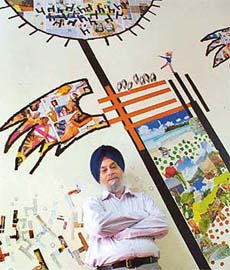 Artist Balwinder, also Principal of the Government College for Men, Sector 11, Chandigarh, beside his beautifully executed collage mural on his office wall