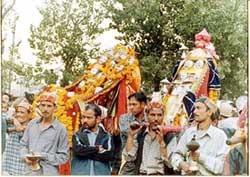 Devotees carry idols during a Dasehra procession in Kulu on Saturday. 