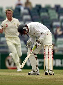 Australian bowler Brett Lee races in after hitting Zimbabwe batsman Trevor Gripper