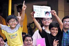Young fans of Bollywood star Amitabh Bachchan wish him on his 61st birthday