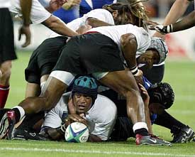 Fiji's Apisai Naevo (C) is surrounded by team-mates during their Rugby World Cup pool B match against France