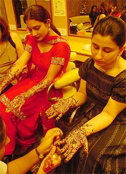 Girls get mehndi applied for Karva Chauth in Ludhiana