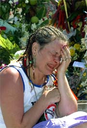 A woman breaks down inside a makeshift memorial to victims of last year�s blasts in Bali