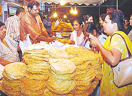 Women busy buying �feni� on the eve of Karva Chauth in Sector 20, Chandigarh, on Monday.