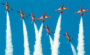 Red Arrow aircraft from the British RAF take part in a joint aerobatics display