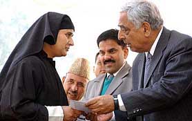 J&K Chief Minister Mufti Mohammad Sayeed hands over an employment order to a woman at a function in Srinagar