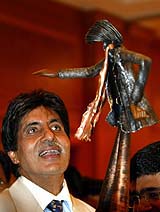Bollywood icon Amitabh Bachchan looks at a sculpture of himself during his birthday celebrations in Mumbai