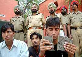 The four accused, who cheated a local tea vendor with a brick of brass, being brought to the Civil Lines police station in Bathinda 