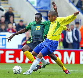Brazil's Ronaldo fights for the ball with Claude Davis of Jamaica during a friendly match at Walker Stadium in Leicester