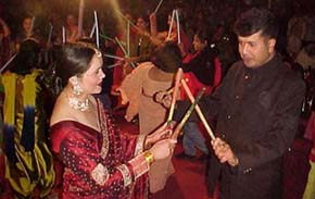 A couple performs Dandia on the eve of Karva Chauth in Shimla on Tuesday