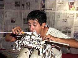 Mexican artist Antonio Salinas performs a native dance with the help of newspapers in Jammu 