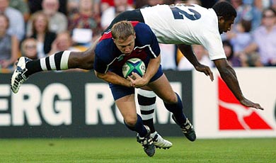 Fiji's Seru Rabeni dives over Paul Emerick of the US during their Rugby World Cup match 