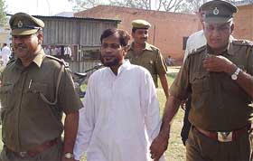 Mr Shahid Ali, former Punjab Wakf Board CEO, being escorted to a court in Ambala 