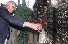 New Zealand's Deniss Marshall, Secretary General of Commonwealth Parliamentary Association, spreads flower petals at a memorial commemorating victims of an October 2001 suicide attack