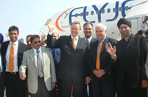 Delegates of the first non-stop tourist chartered flight from England to Amritsar wave to mediapersons