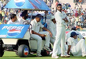 A dejected Indian team takes rest during drinks on the second day of the second Test at PCA Stadium, Mohali. � Tribune photo by Manoj Mahajan