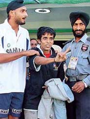 Cricketer Harbhajan Singh comes to the rescue of a fan of the Indian cricket team, Vijay Jairam Gaundalkar, who was caught for breaching security at the PCA Stadium