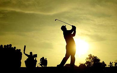 Fiji's Vijay Singh plays his second shot on the first fairway 