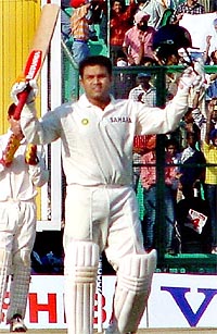 Virender Sehwag acknowledges his century against New Zealand on the third day of the second Test at PCA Stadium