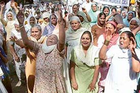 Wailing mother and wife (first and second from left) of murdered Avtar Singh protest in front of the Sector 11 police station in Chandigarh on Monday.