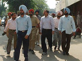 Vigilance Bureau officials take away accused from the Civil Hospital