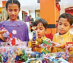 Kids select chocolates at an exhibition of home-made assorted chocolates in Sector 17, Chandigarh