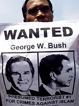 An Indonesian youth holds an anti-US poster outside the US Embassy in Jakarta 