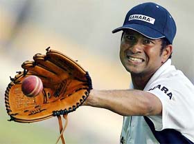 Sachin Tendulkar catches a ball during a practice session in Chennai 