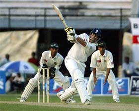 English batsman Marcus Trescothick hoists Bangladeshi bowler Mashrafe Mortaza for a four as wicketkeeper Khaled Masud and Habibul Bashar look on