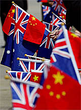 Members of the Chinese community waves Australian and Chinese flags upon the arrival of Chinese President Hu Jintao at Sydney airport