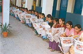 Students of the BR DAV College for Women, Kurali, who have formed The Tribune Club, read the paper.