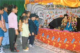 Students of Kiddies Paradise watch a puppet show during Divali celebrations